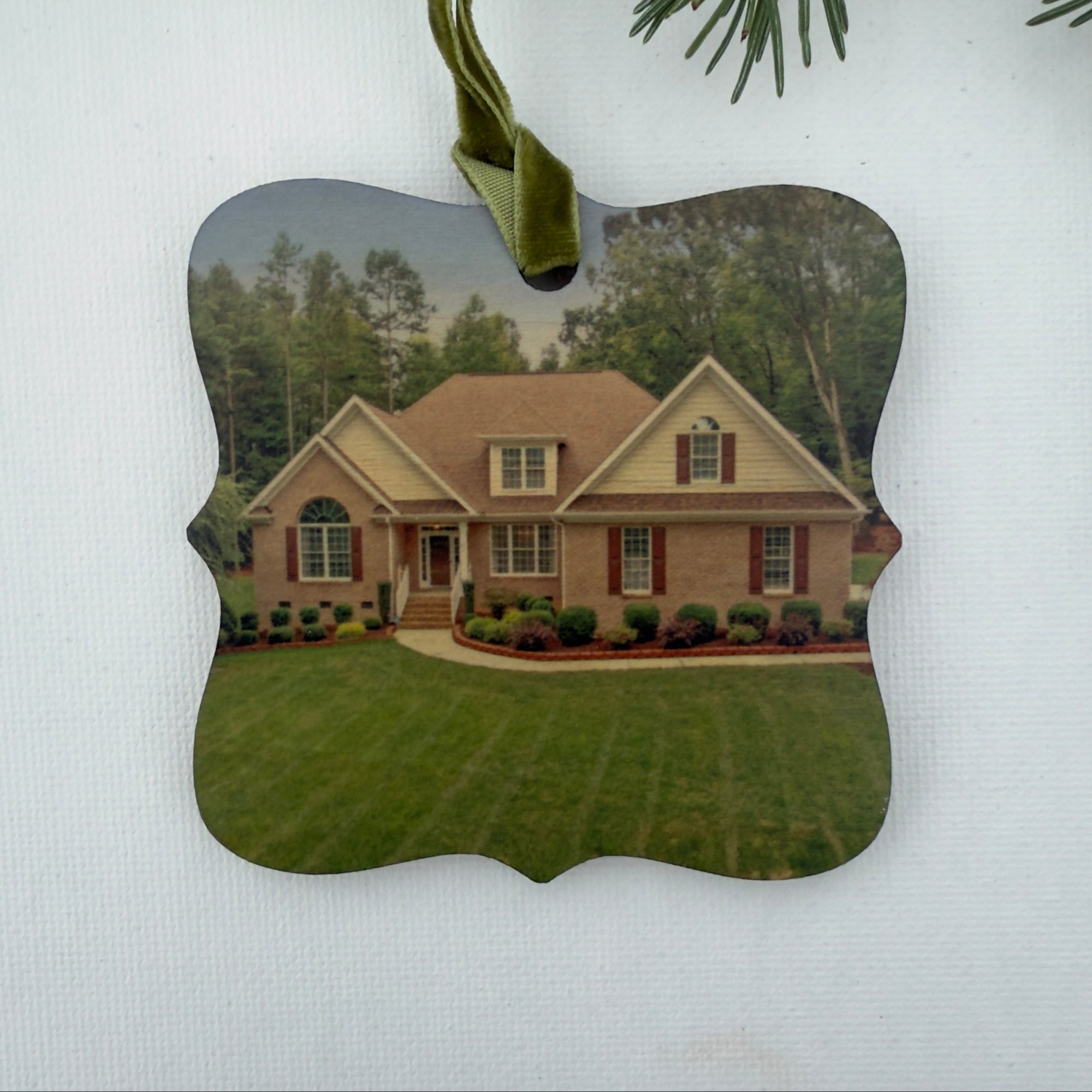 A wooden ornament with a photo of a house on it for a 'Closing Gift' from a realtor.